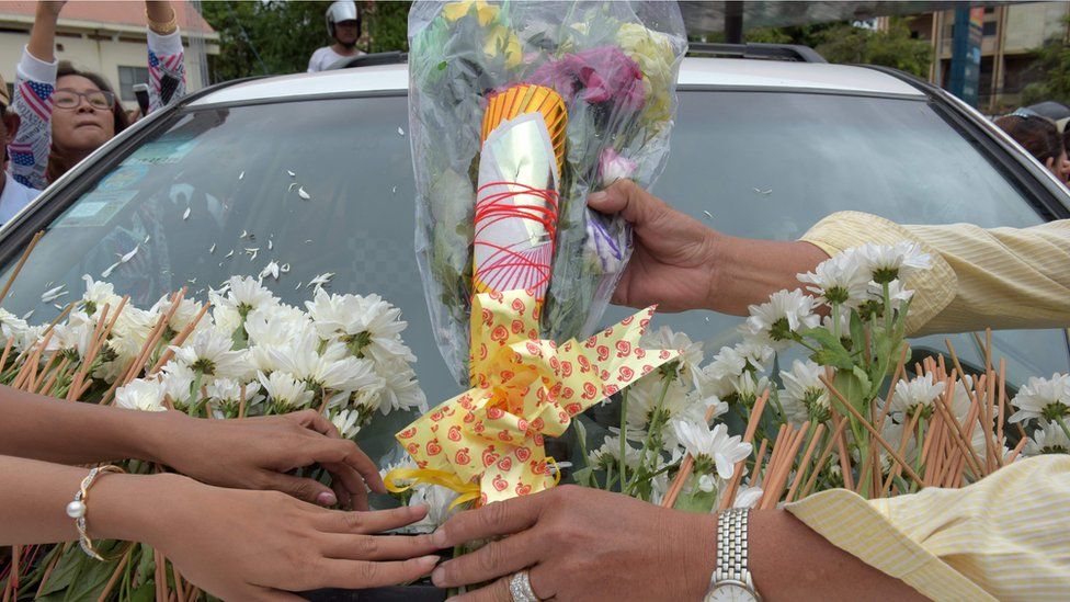 Cambodians lay flowers on the car carrying the body of political analyst Kem Ley, shot dead on Sunday in Phnom Penh (10 July)