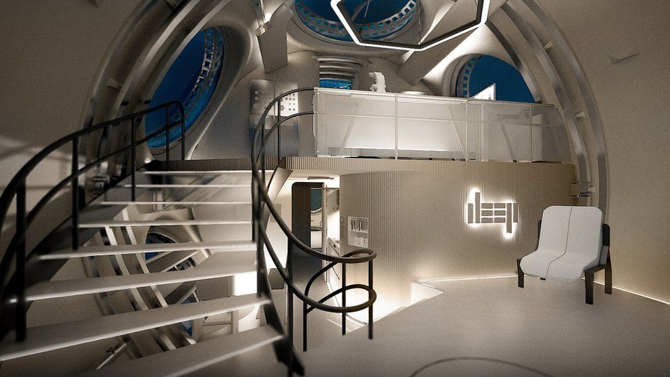 The inside of a futuristic-looking pod for underwater living showing furniture and stairs