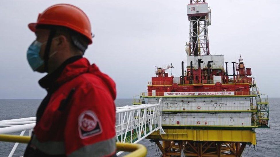 An employee is seen at an oil platform operated by Lukoil company at the Kravtsovskoye oilfield in the Baltic Sea, Russia