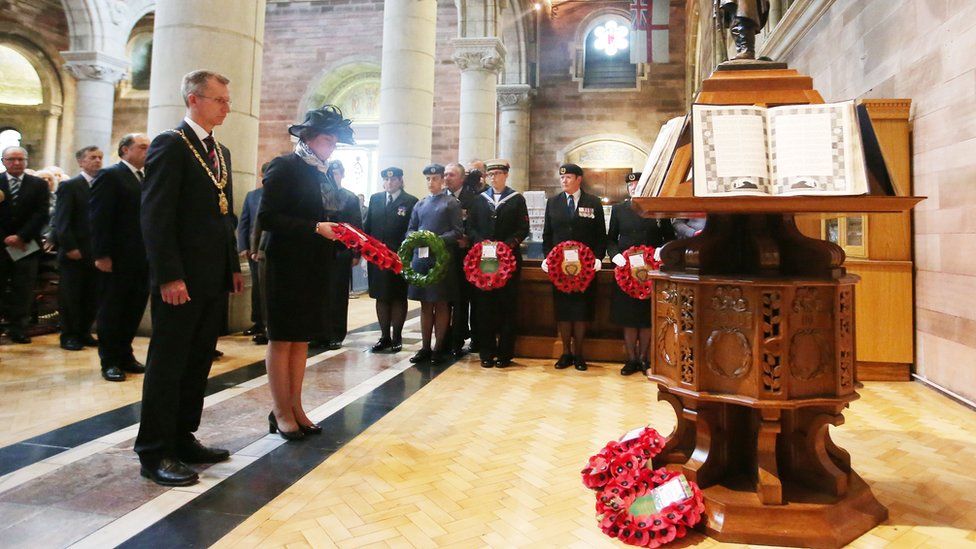 First Minister Arlene Foster lays a wreath during the service