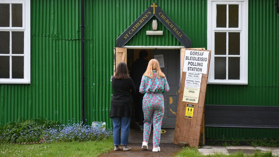 People going into St Catherine's church hall polling station, Cardiff, to vote in the Welsh Parliamentary Elections