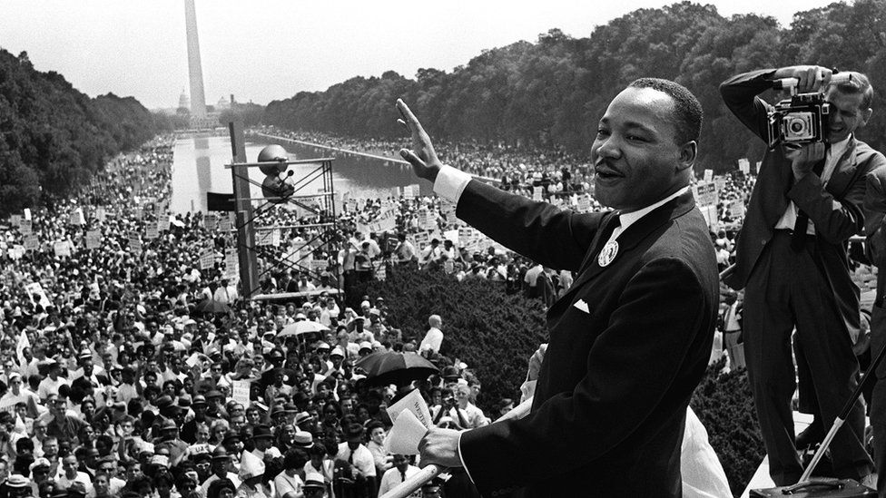 Civil rights leader Martin Luther King (C) waves to supporters 28 August 1963 on the Mall in Washington, DC,