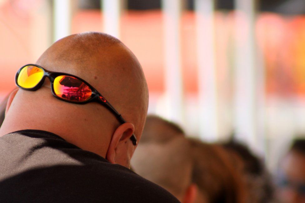 Mirrored sunglasses on the back on a man's head