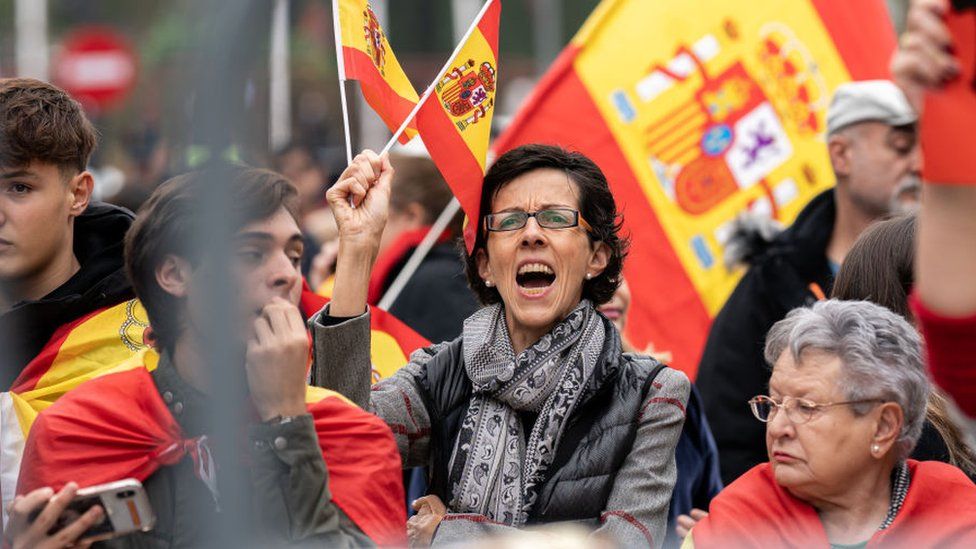 A demonstrator with a Spanish flag during a protest against the investiture of Pedro Sanchez