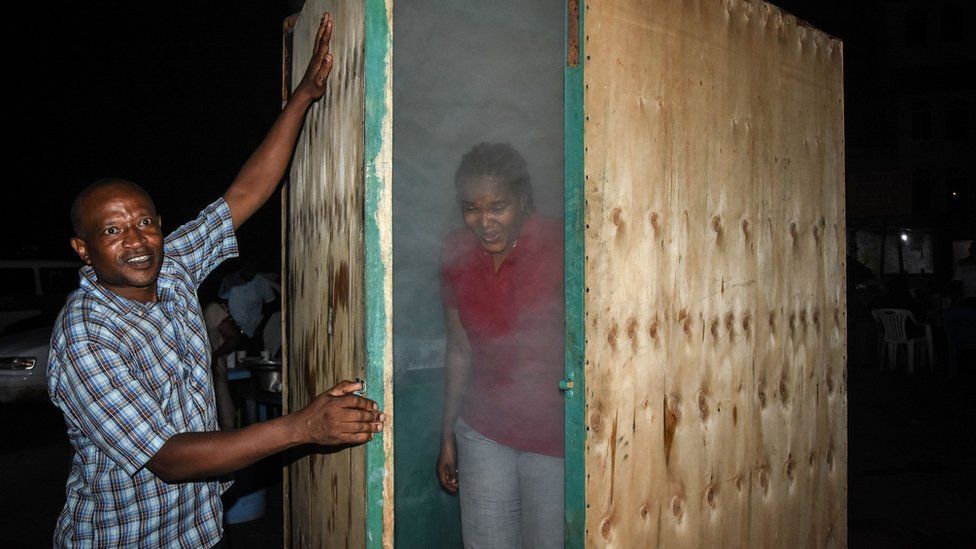 A woman coming out of a steam inhalation booth installed in Dar es Salaam