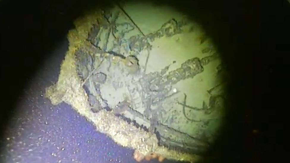 Underwater stills show the ship's intact bow, anchors and anchor chains