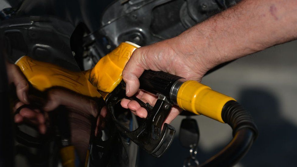 Man's hand pumping petrol