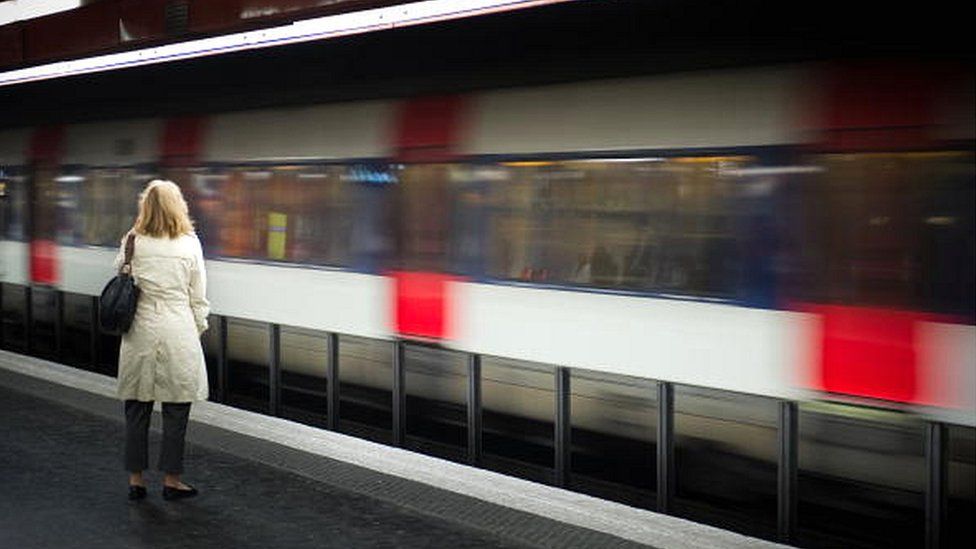 File picture of a woman waits for a train on a platform at Auber train station in Paris