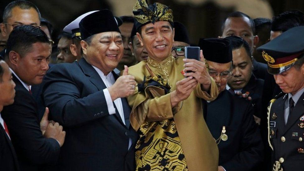 Mr Widodo poses for a selfie with a member of parliament in August