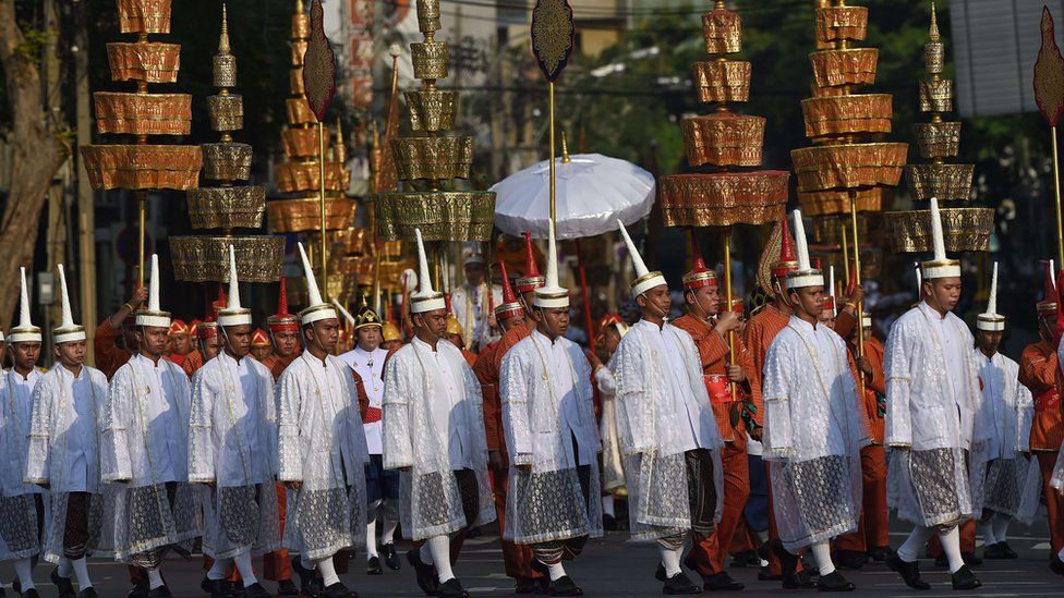 Men in ceremonial uniforms walk in a procession transporting the royal urn containing the remains of Thailand's most senior Buddhist monk, the late Supreme Patriarch Somdet Phra Nyanasamvara, in Bangkok