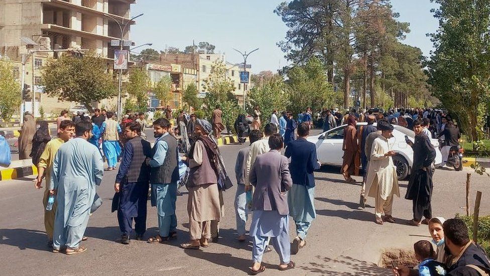 People leave buildings in Herat after the earthquake