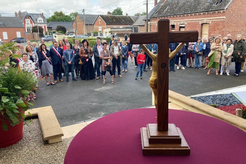 Crucifix with people in background