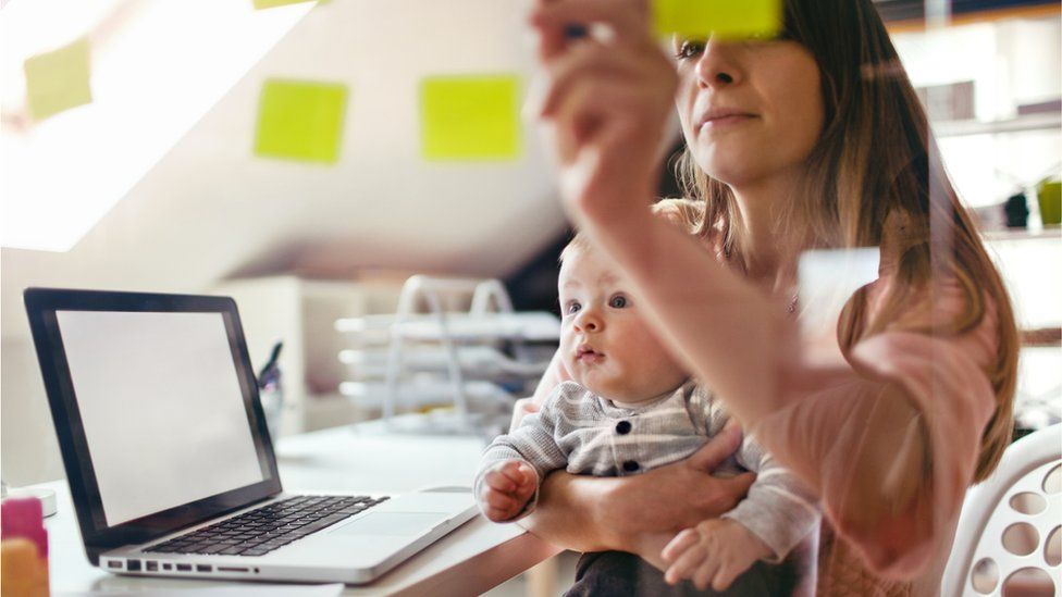 Mother working with child on lap