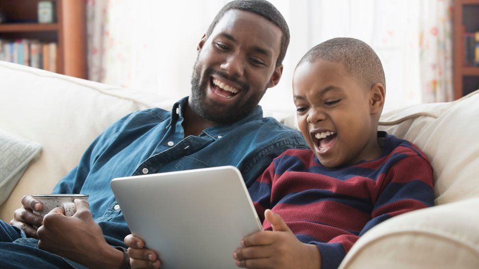 Man and boy looking at tablet