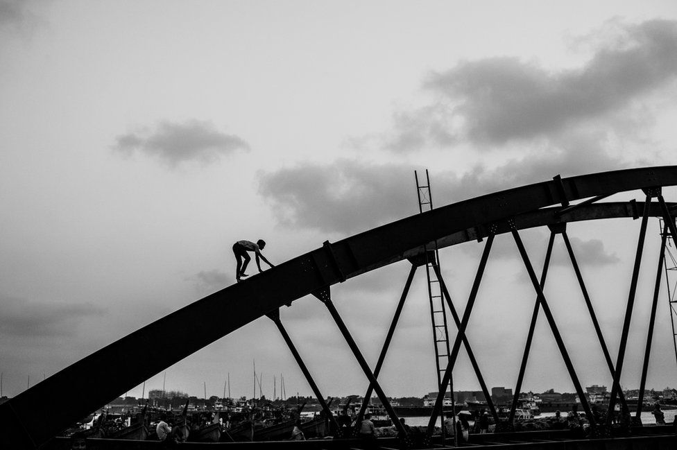 Man on a bridge in Chittagong, Bangladesh
