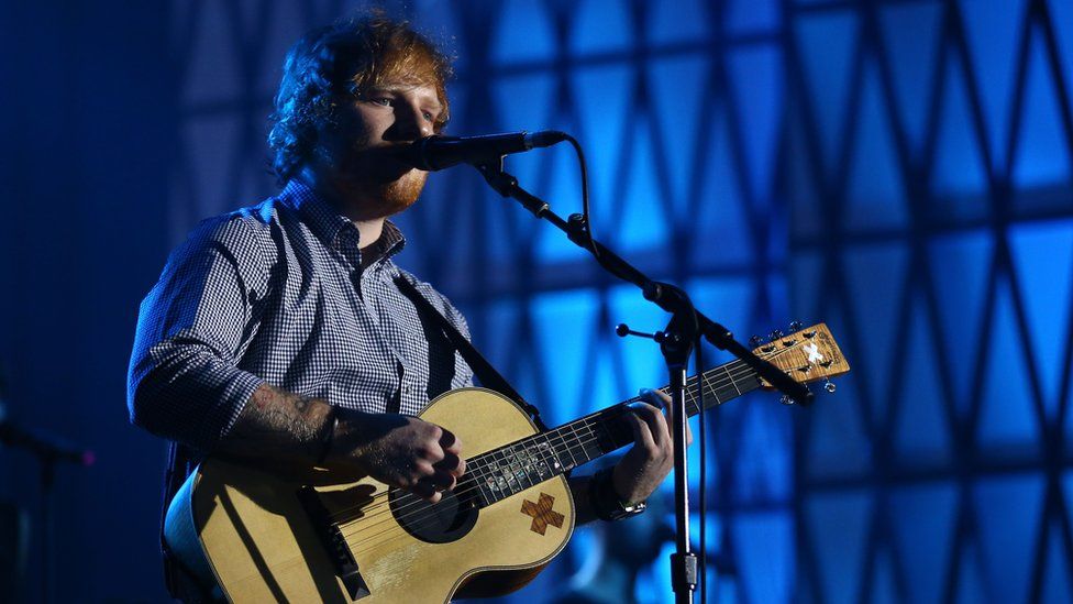 Ed Sheeran performing with a guitar