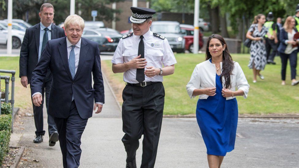 Britain's Prime Minister Boris Johnson and Home Secretary Priti Patel with Chief Constable Dave Thompson meet graduates from a West Midlands Police training centre in Birmingham