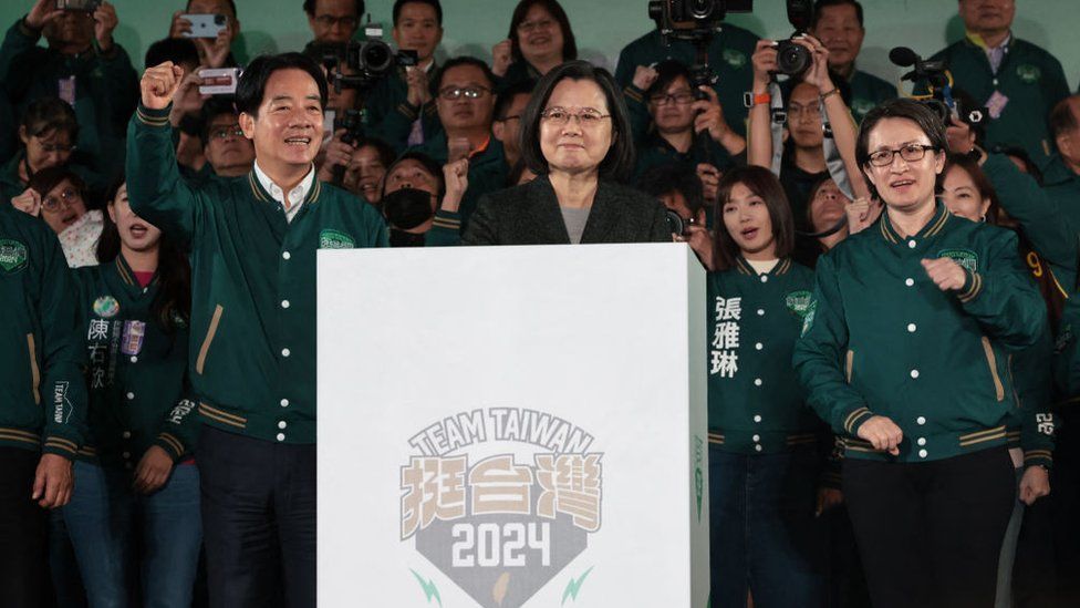 Taiwan's President Tsai Ing-wen (C), President-elect Lai Ching-te (L) and his running mate Hsiao Bi-khim attend a rally outside the headquarters of the Democratic Progressive Party (DPP) in Taipei
