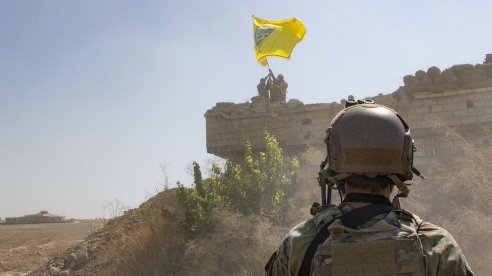 US soldier looks at SDF troops dismantling YPG outpost, September