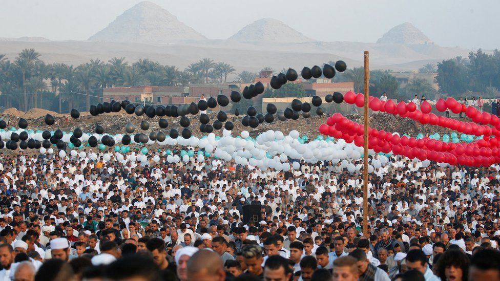 People gathered under balloons in the colours of the Palestinian flag in at the village of Abu Sir, in the Giza Governorate, Egypt.