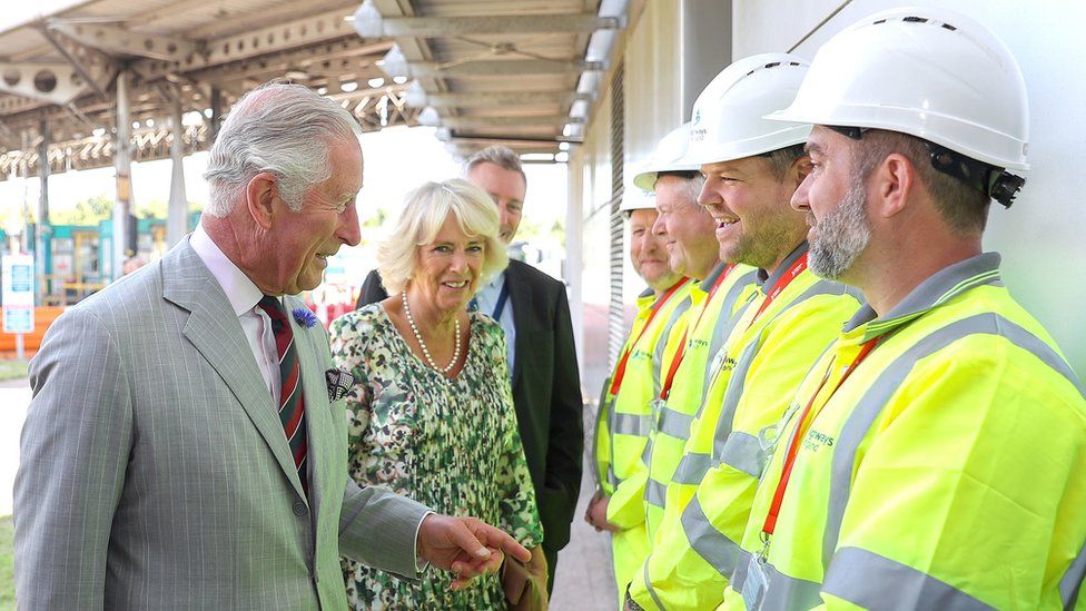 The Prince of Wales and Duchess of Cornwall speak to workers at the bridge's toll booths