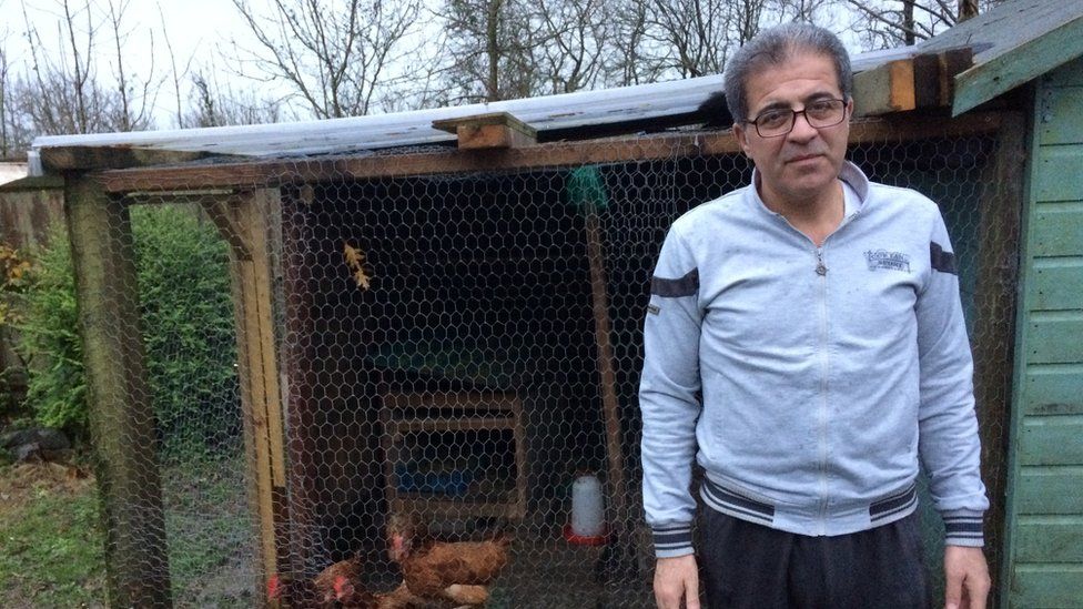 Ahmad Batak with his chickens