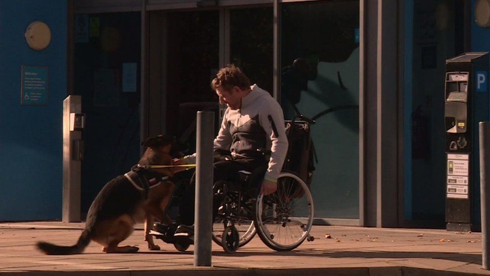 Piotr Rembikowski with his dog outside the hotel he had been staying in