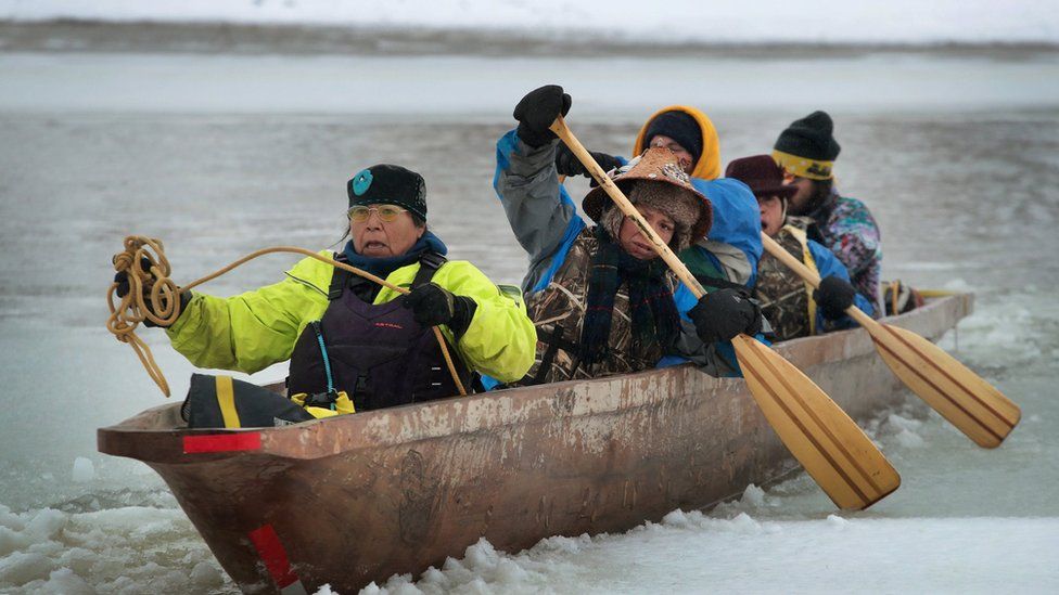 Native Americans from Washington state arrive at Oceti Sakowin Camp on the edge of the Standing Rock Sioux Reservation after traveling from the headwaters of the Missouri River in a dugout canoe on December 1, 2016 outside Cannon Ball, North Dakota.