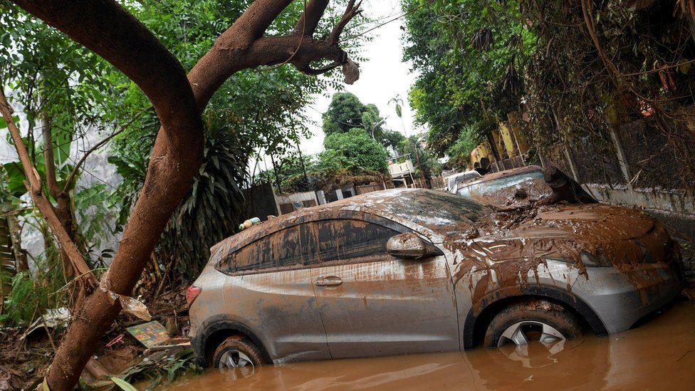 Cars damaged by floods following heavy rains sit in floodwater at a residential area in Bintaro, Jakarta, Indonesia, January 3 2020