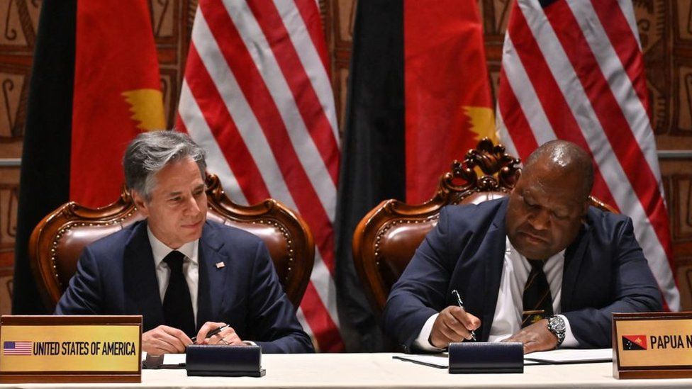 US Secretary of State Antony Blinken (L) and Papua New Guinea's Defence Minister Win Bakri Daki (R) sign security agreements