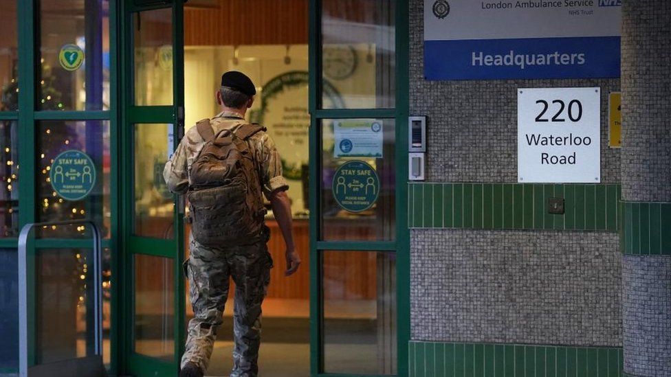 A military personnel enters the Waterloo ambulance station in London, as paramedics, ambulance technicians and call handlers walk out in England and Wales, in a strike co-ordinated by the GMB, Unison and Unite unions over pay and conditions