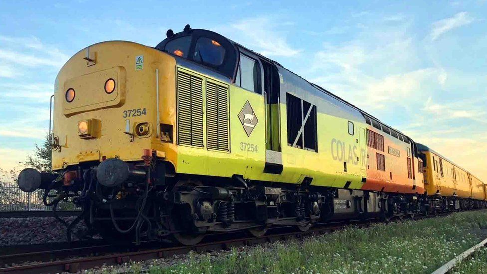 Yellow diesel locomotive Class 37 No. 37 254 with Colas Rail logo on the site