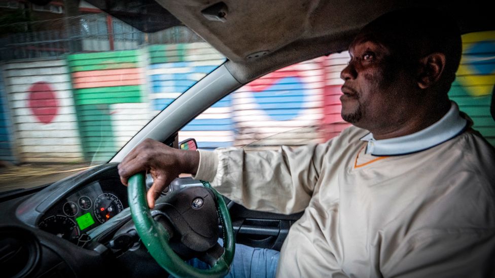 Jafter Ndlovu in his taxi in Hillbrow, Johannesburg, South Africa