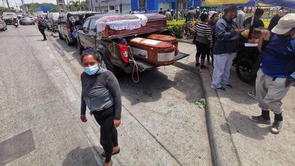 A car exhibiting coffins is parked outside the morgue in Guayaquil