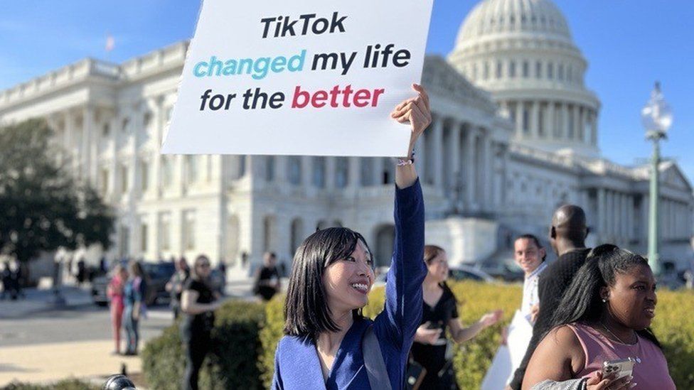 Tiffany Yu holds up a sign at the US Capitol that reads, "TikTok changed my life for the better"