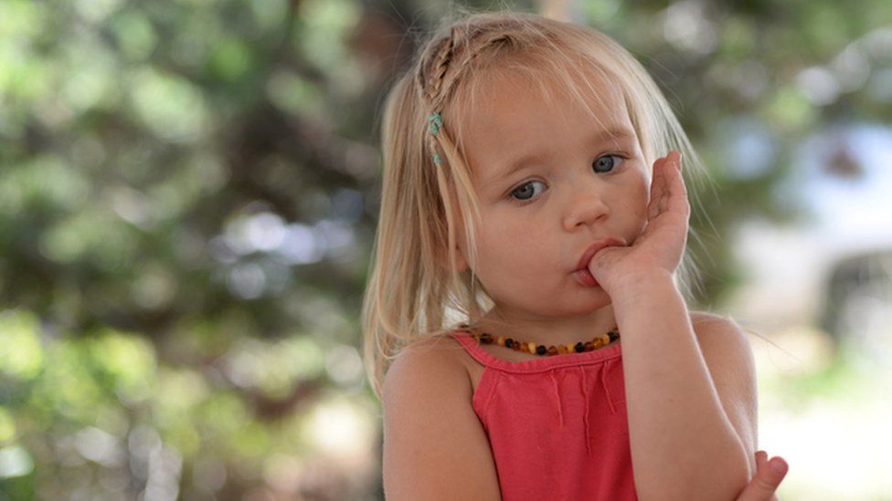young girl sucking her thumb