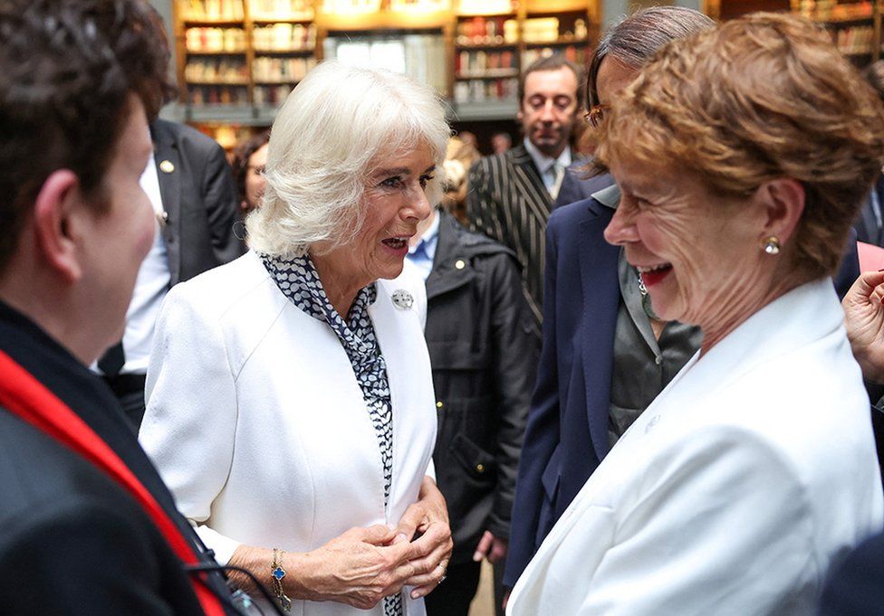 Queen Camilla shares a joke with Celia Imrie at the reception