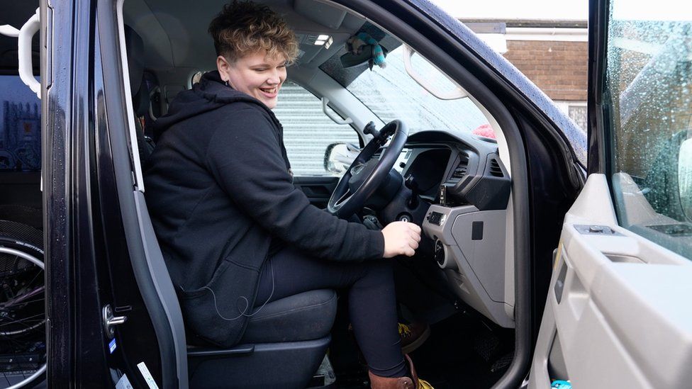 Georgie at the wheel of her van