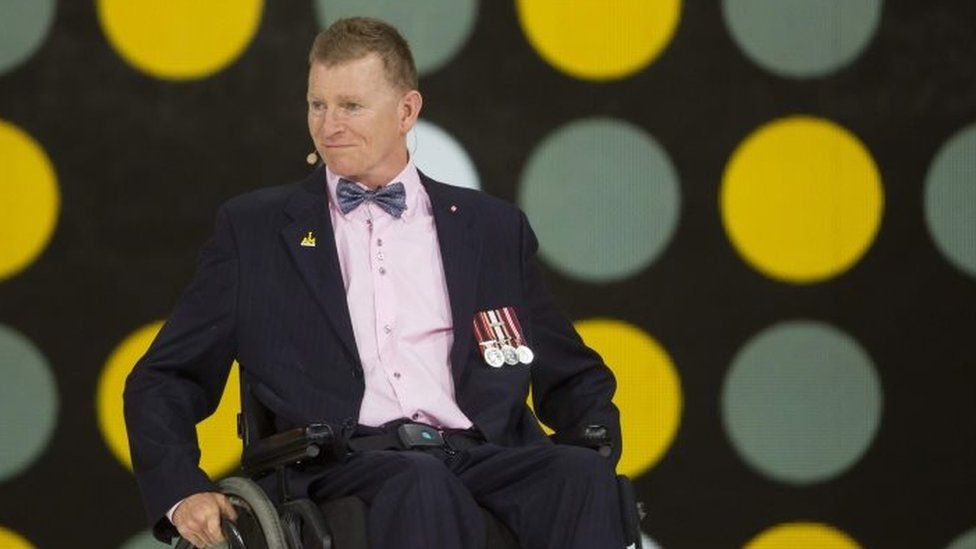Retired Captain Trevor Greene of the Canadian Armed Forces speaks during the opening ceremony