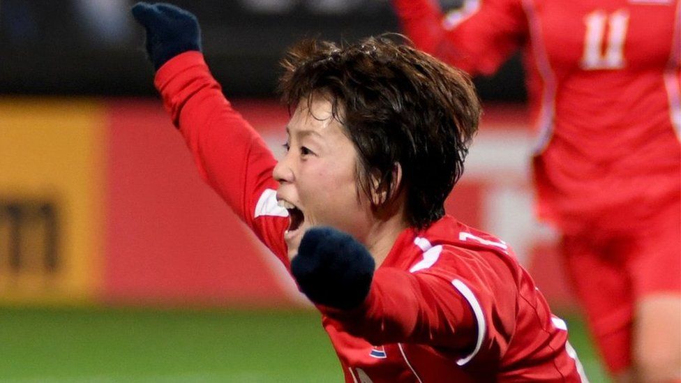 A North Korean footballer celebrates her team's goal against Japan