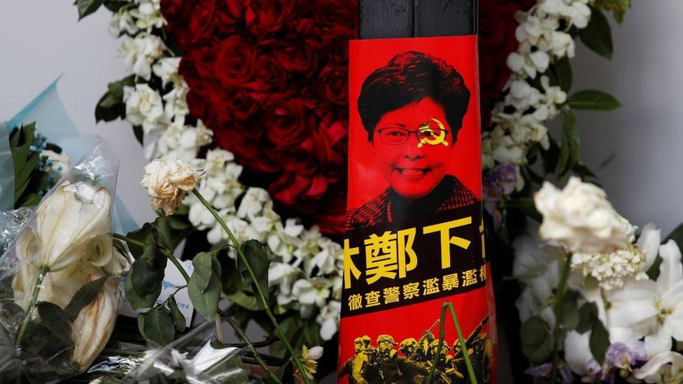 Picture of Carrie Lam with hammer and sickle across her face