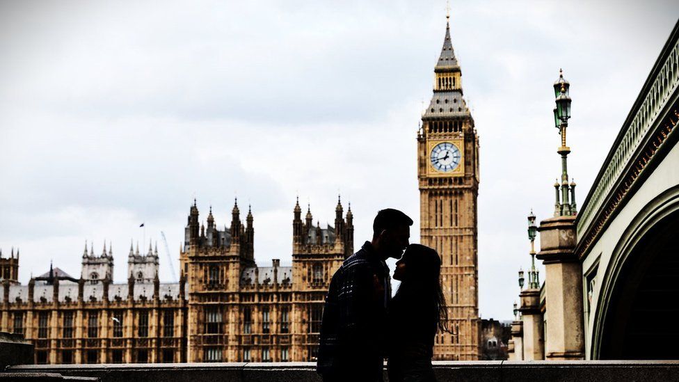 unidentified couple kissing