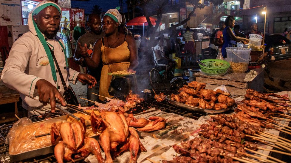 Street food vendors preparing roasted meat in Jinja, Uganda - Wednesday 2 February 2022
