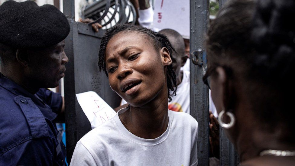 A voter pushes through the crowd into a polling station in Kinshasa on December 20, 2023.