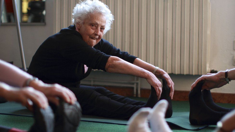 Older woman exercising with others