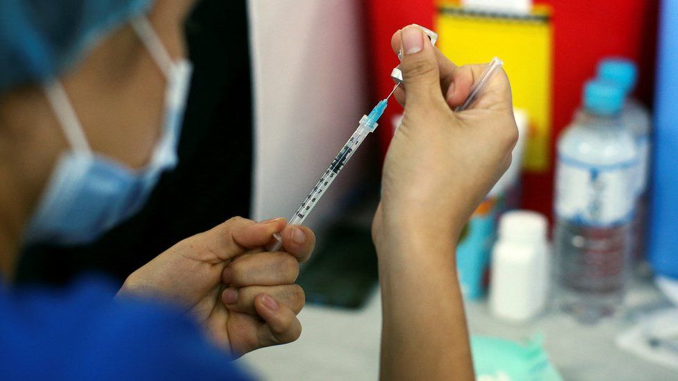 A healthcare worker prepares a dose of Pfizer-BioNTech coronavirus disease (COVID-19) vaccine
