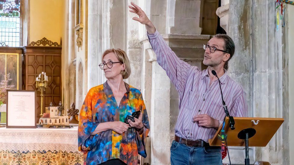 Committee member Sally Cassels (L) and stained glass artist Ben Finn (R) discussing the design