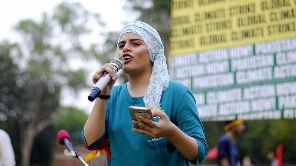 Laiba Siddiqi speaks on stage at a march