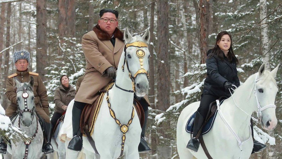 An undated picture released by North Korea's official Korean Central News Agency (KCNA) on 4 December, 2019 shows North Korean leader Kim Jong-un (C) riding a horse as he visits battle sites at Mount Paektu, Ryanggang.
