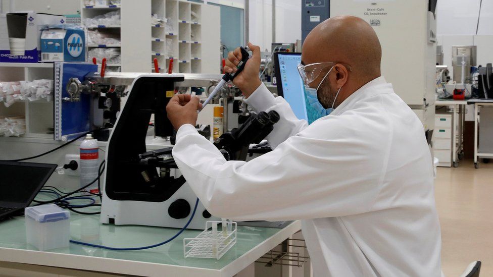 A researcher works in an industrial development laboratory at Sanofi's vaccine unit